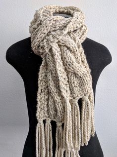 a white knitted scarf on top of a mannequin