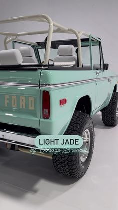 an old ford bronco pick up truck with the hood down and four seats folded back