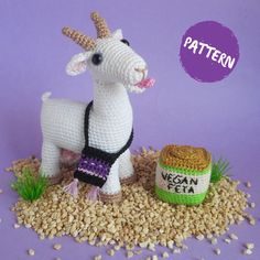 a small crocheted goat next to a bowl of oatmeal on a purple background