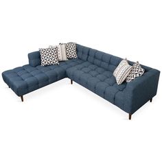 a blue sectional couch with pillows on it