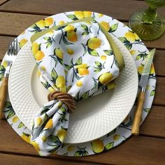 a white plate topped with a napkin covered in lemons