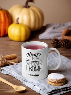 a mug with tiny human tamer written on it next to cinnamon sticks and pumpkins