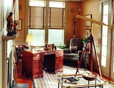 a living room filled with furniture and lots of windows