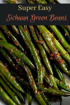 some green beans on a white plate with seasoning sprinkled around them and the words super easy sicilian green beans