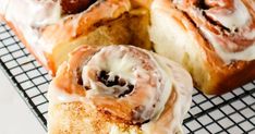 cinnamon rolls with icing on a cooling rack