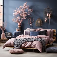 a bedroom with blue walls, pink bedding and pillows on the bottom half of the bed