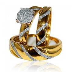 two gold wedding rings with diamonds on each one and an engagement ring in the middle