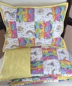 a chair with pillows and blankets on top of it in the shape of rainbows