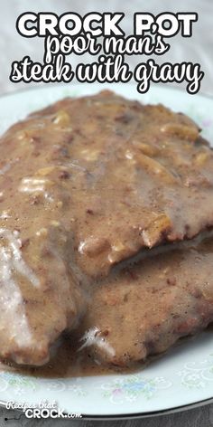 two meat patties covered in gravy on a plate with the words crock pot pork mars steak with gravy