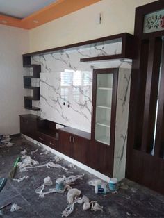 a living room that is being remodeled with marble walls and cabinets in the process of remodeling