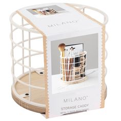 a white container with makeup brushes in it and a wooden tray underneath the lid that holds an image of millanoo's storage caddy