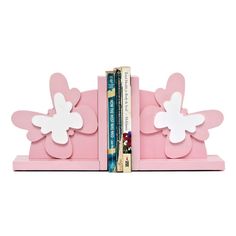 a pink bookend with white flowers on it and books in front of the back