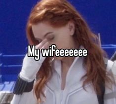 a woman with red hair is holding her hand up to her face and the caption reads, my wifeeee