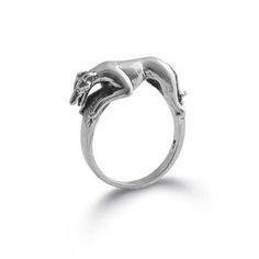 a silver ring with a horse on it's back end and two hands in the middle