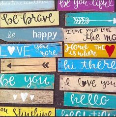 colorful painted wood signs with words on them that say be brave, love, and affection