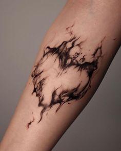 a black and white tattoo on the arm of a person's leg with an abstract design