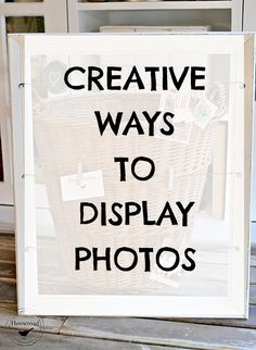 a white frame with the words creative ways to display photos on it in black lettering