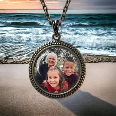 "Customized with your OWN PHOTO. Gorgeous LARGE sized pendant necklace with deluxe bail includes a 24\" etched vintage-style chain. Bring a personalized look to every outfit with this unique photo necklace. It makes a great gift for birthdays, anniversaries, graduation or any special event.  Your photo will be cropped to fit perfectly into the image area and covered by a pure glass domed cabochon that protects and magnifies the image.  Offered in either antique silver (shown) or antique bronze f Personalized Bronze Pendant Jewelry, Retro Necklace With Lobster Clasp As Gift, Retro Necklaces With Lobster Clasp As A Gift, Retro Necklaces With Lobster Clasp For Gifts, Vintage Personalized Jewelry For Collectors, Vintage Locket Charm Necklace For Mother's Day, Vintage Round Pendant Jewelry For Mother's Day, Vintage Round Jewelry For Mother's Day, Retro Nickel Free Necklace For Gift