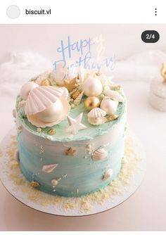 a birthday cake decorated with seashells and starfish