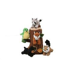 an assortment of stuffed animals sitting on top of a tree stump