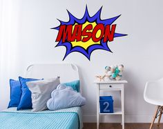 a bedroom with a bed, nightstand and wall decal that says mason on it