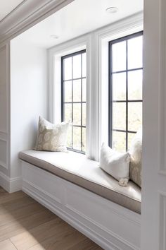 a window seat with two pillows on it