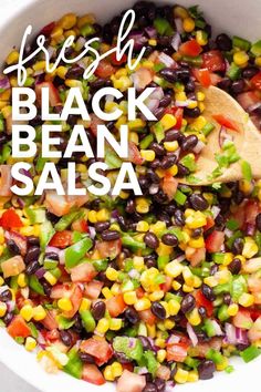 fresh black bean salsa in a white bowl with a wooden spoon and text overlay