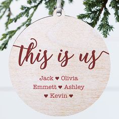 this is us ornament hanging from a tree