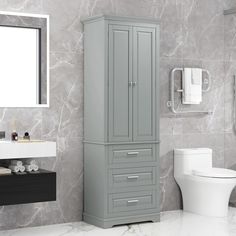 a white toilet sitting next to a tall gray cabinet in a bathroom under a mirror