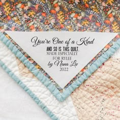 a close up of a piece of fabric on a quilted surface with the words you're one of a kind and so is this quilt made especially for style