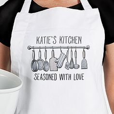 a woman wearing an apron with cooking utensils on it