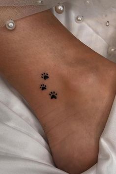 a woman's foot with two paw prints on her left side and the other one is