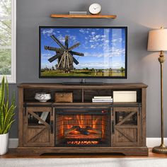 an entertainment center with a television and fireplace