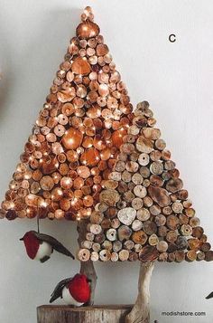 a christmas tree made out of wine corks with birds perched on the stumps