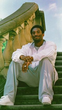 a man sitting on some steps with his hands crossed