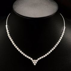 She'll never tire of wearing this classic and sophisticated diamond tennis necklace. Stunning in 18K solid white gold, this breathtaking line of shimmering round diamonds. So elegant, this 18.0-inch diamond necklace will take her breath away. Radiant with 3.08 cts. t.w. of diamonds and buffed to a brilliant luster, this glamorous keepsake secures with a box clasp. The setting design make the diamonds look much bigger than they are. When worn, the diamonds look like 1/5 carat each. Diamonds Detai Timeless Diamond Cut Tennis Necklace For Wedding, Timeless Diamond White Tennis Necklace For Wedding, Wedding Tennis Necklace With Brilliant Round Cut, Wedding Tennis Necklace In White Gold With Round Cut, Brilliant Cut Tennis Necklace For Wedding, Classic Diamond Tennis Necklace For Wedding, White Gold Tennis Necklace With Round Cut For Weddings, White Gold Tennis Necklace For Wedding, Classic Bridal Necklace With Round Cut Single Diamonds