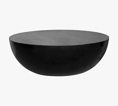 a black bowl sitting on top of a white table