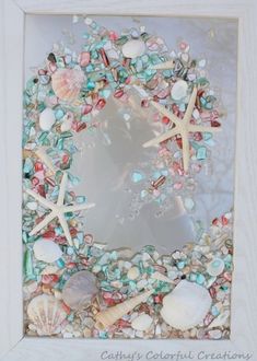 a white frame filled with sea shells and starfish