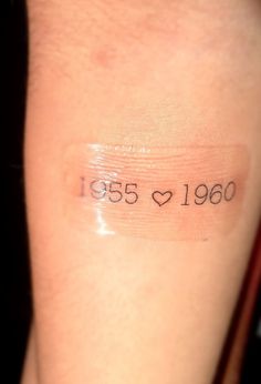 the back of a woman's arm with an inscription on it that reads, 1953 - 1960