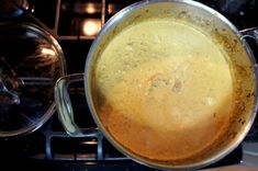 a pot with some food in it sitting on top of an open stove burner