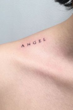 an angel tattoo on the back of a woman's neck