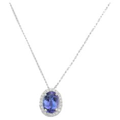 Everyday Halo Diamond Tanzanite Solitaire Necklace in 18K Gold with diamond studded around oval tanzanite. This stunning piece of jewelry instantly elevates a casual look or dressy outfit. Tanzanite brings energy, calmness and happiness into life. Designed with oval cut tanzanite surrounded with diamonds making a stunning delicate necklace. This beautiful handcrafted necklace is a perfect Unique Gift, Bridal Shower Gift, Secret Santa Gift, Gift For Sister, Mother Daughter Gift, Bride To Be Gift, Luxury Oval Tanzanite Necklaces, White Gold Tanzanite Necklace For Formal Occasions, Formal White Gold Tanzanite Necklace, Elegant Tanzanite White Gold Necklace, Elegant Tanzanite Necklace For Formal Occasions, Elegant White Gold Tanzanite Necklaces, Elegant Formal Tanzanite Necklaces, Elegant Formal Tanzanite Necklace, Elegant Tanzanite Oval Pendant Jewelry