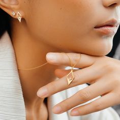 This stunning necklace features a sleek and modern design, crafted from recycled 14ct gold vermeil for a luxurious finish. The geometric pendant showcases a unique diamond shape, adding a bold touch to any outfit. Suspended from a delicate gold chain, the pendant elegantly frames a central accent, making it a perfect statement piece for both day and night.   Available in sterling silver & 14ct gold vermeil. Designed in the UK Crafted in recycled 14ct gold vermeil Cubic zirconia Lobster clasp fas Modern Single Diamond Jewelry In Diamond White, Modern Everyday Luxury Diamond Necklace With Diamond Cut, Modern Everyday Luxury Diamond Necklace, Modern Diamond Necklace As A Gift, Modern Diamond Necklace For Gift, Modern Diamond Cut Necklace In Diamond White, Modern Diamond Cut Pendant Necklace, Modern Diamond White Diamond Necklace, Modern Diamond Cut Necklace