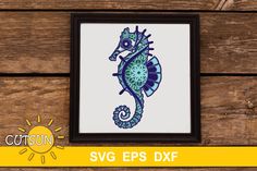 a blue and green seahorse on a wooden background with the words svg eps dxf