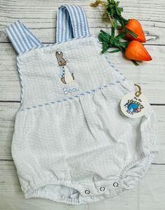 Adorable embroidered Easter bunny rabbit themed sunsuit.  Perfect for that Easter & warm weather. Every item is made by hand and handled with a lot of love and care. Each item can result in a bit different placement then the example pictures as each item is placed by hand by me. All sunsuits have a soft backing ironed on to the back of the embroidery so it's soft against your child's skin.  Brand & Model: DinoSewSuite/ LTC. All Sunsuits fit true to size and are boutique quality outfits for embroidery.   100% combed cotton interlock cotton. Smoke free, Dog friendly home.  sizes: NB now available in white w/ blue seersucker and light blue 3M, 6M, 12M, 18M & 2T - All colors listed below come in these sizes Jax is wearing size 6M he is 5 1/2 months and weights 15.5Lbs Some sizes are limited. Bunny Themed Outfit, Quality Outfits, Holiday Fits, Embroidered Bunny, Custom Easter, Brand Model, Personalized Easter, Bubble Romper, Easter Rabbit