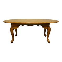 an oval wooden table with two legs on the top and one leg raised to the side