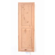 an unfinished wooden door on a white wall