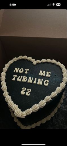 a heart shaped cake with the words not me turning 22 written on it in white frosting