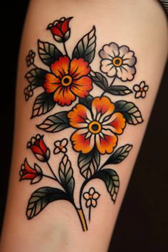 an orange and black flower tattoo on the leg