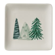 a white plate with green trees painted on it